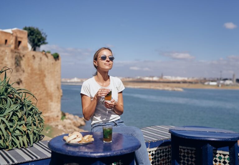 A,Woman,In,Sunglasses,Enjoys,A,Drink,At,An,Outdoor A,Woman,In,Sunglasses,Enjoys,A,Drink,At,An,Outdoor